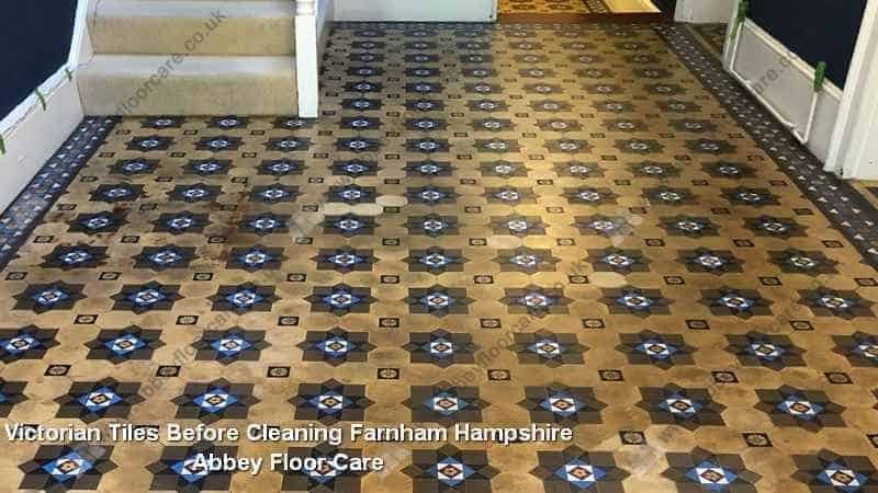 Victorian hallway tiles in Farnham darkened by trapped residue and old surface coatings