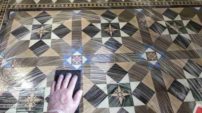 Hand scrubbing Victorian tiles to loosen grime before professional extraction stage