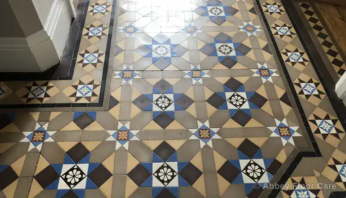 Victorian clay tiles showing dished wear patterns along heavy foot traffic areas