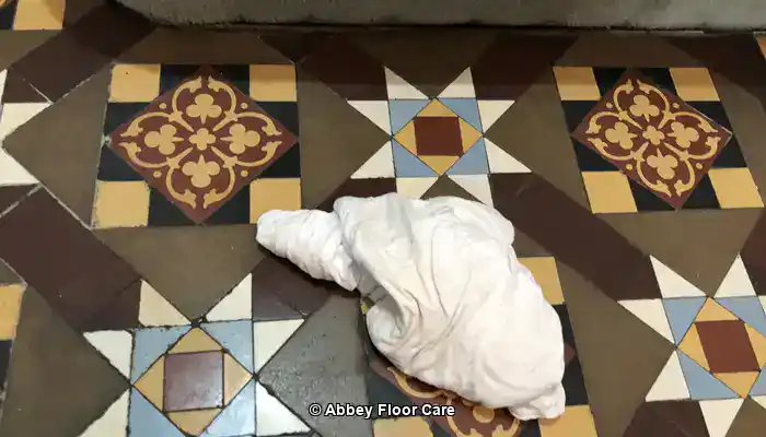 Victorian geometric floor before restoration showing worn surfaces and ingrained dirt