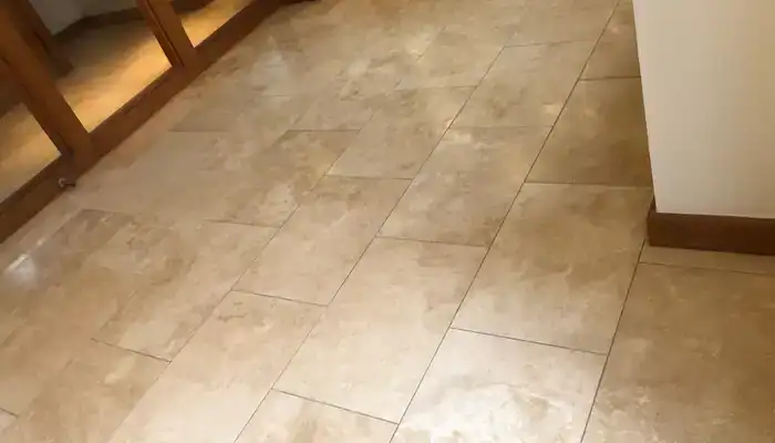 Travertine floor restored to an even natural finish displaying consistent surface tone