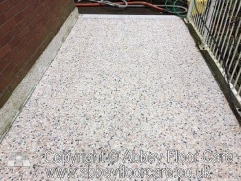 Restored outdoor terrazzo patio with a clean, even finish